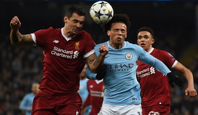 Dejan Lovren (kiri) dan Leroy Sane (kanan) terlibat duel udara saat pertemuan di Liga Champions pada 10 April 2018 (Paul Ellis/AFP)