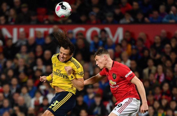 Pemain Manchester United Scott McTominay berebut bola dengan David Luiz. Pada laga Manchester United vs Arsenal yang dihelat Selasa (1/10/2019) dini hari tadi laga berakhir imbang 1-1. [PAUL ELLIS / AFP]