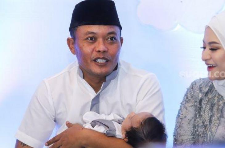 Komedian Entis Sutisna atau Sule sambil menggendong putranya, Adzam Adriansyah Sutisna saat menggelar jumpa pers usai acara akikah di Tambun, Bekasi, Jawa Barat, Jumat (21/1/2022). [Suara.com/Alfian Winanto]