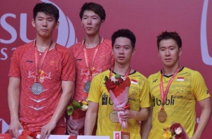 Pasangan ganda putra Indonesia, Kevin Sanjaya Sukamuljo/Marcus Fernaldi Gideon (baju kuning), menjuarai Indonesia Masters 2018 usai mengalahkan Li Jun Hui/Liu Yu Chen (China) yang dijuluki Duo Menara di Istora Senaya, Jakarta, Minggu (28/1/2018). [AFP/Adek Berry]