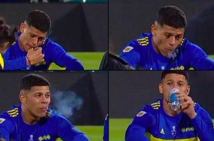 Aksi Marcos Rojo merokok dan minum bir usai antar Boca Junior raih trofi. (Twitter/@TyCSports)