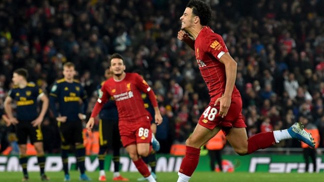 Sejumlah pemain Liverpool merayakan gol gelandangnya, Curtis Jones sebagai algojo terakhir penalti usai menundukkan Arsenal pada Piala Liga Inggris 2019/20 di Stadion Anfield, Kamis (31/10/2019). [Paul ELLIS / AFP]