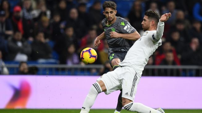 Winger Real Sociedad, Adnan Januzaj (kiri) berduel dengan bek Real Madrid, Sergio Ramos. [GABRIEL BOUYS / AFP]