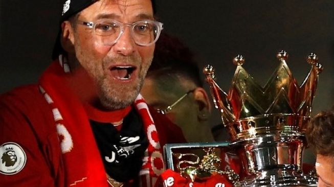 Manajer Liverpool Jurgen Klopp (kiri) mengangkat trofi Liga Inggris usai menghadapi Chelsea di Anfield. PHIL NOBLE / POOL / AFP